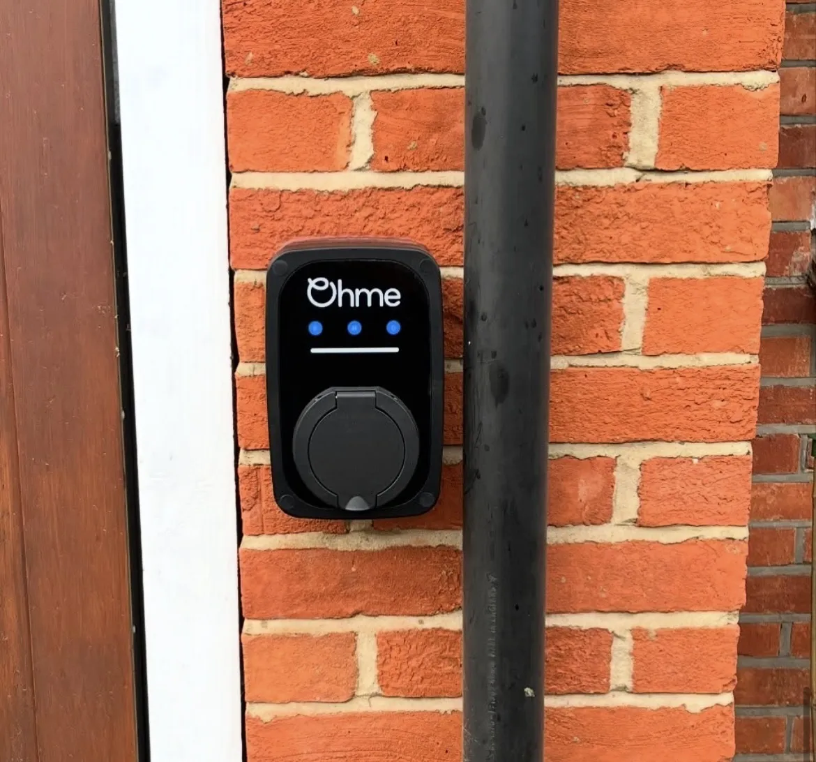 Ohme EV charger installed on a house wall