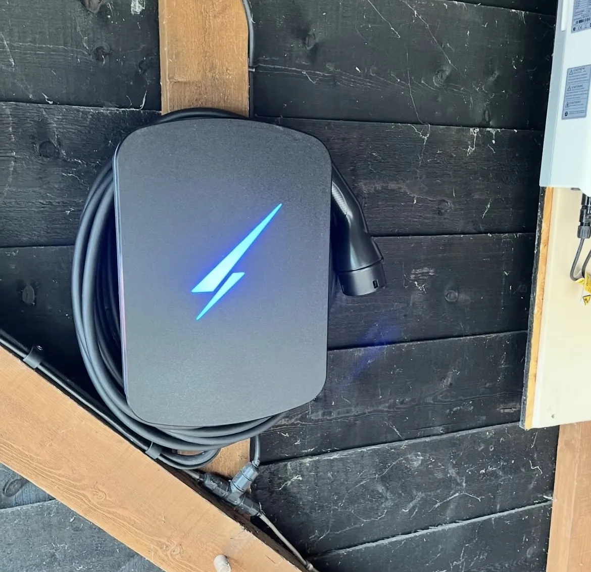 Home EV charger installed on an exterior wall