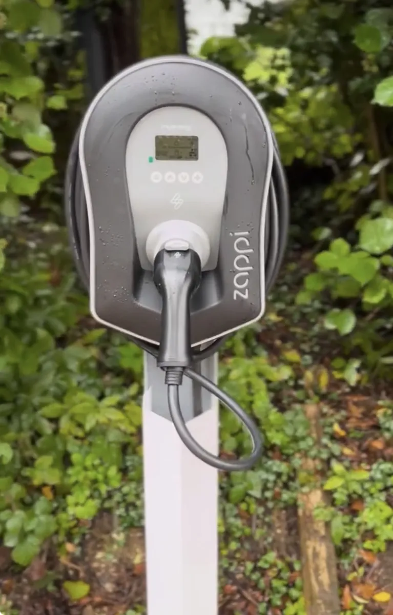 Zappi EV charger installed on a house wall