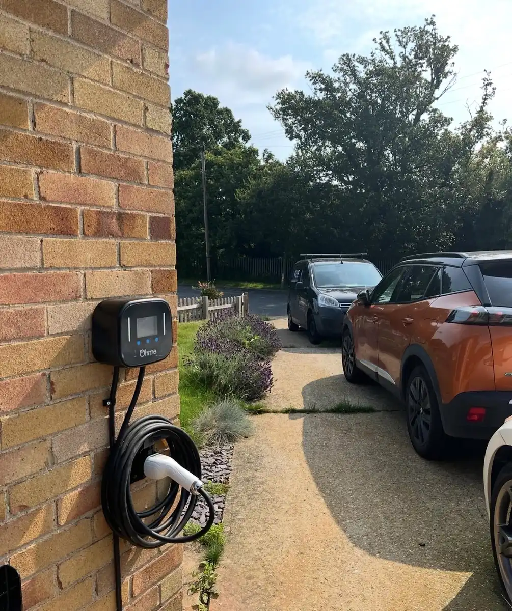 Ohme EV charger installed on a house wall